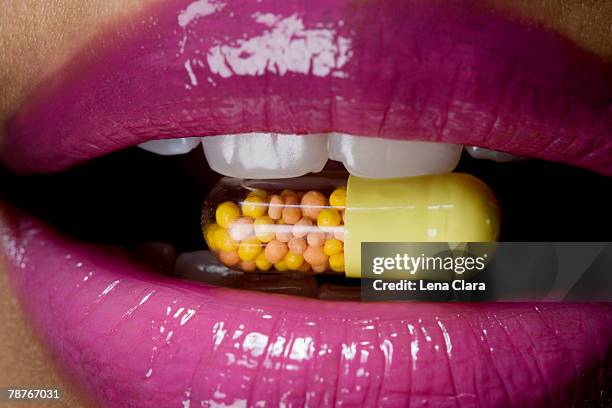 a vitamin pill inside a woman's mouth - pink vanity stock pictures, royalty-free photos & images