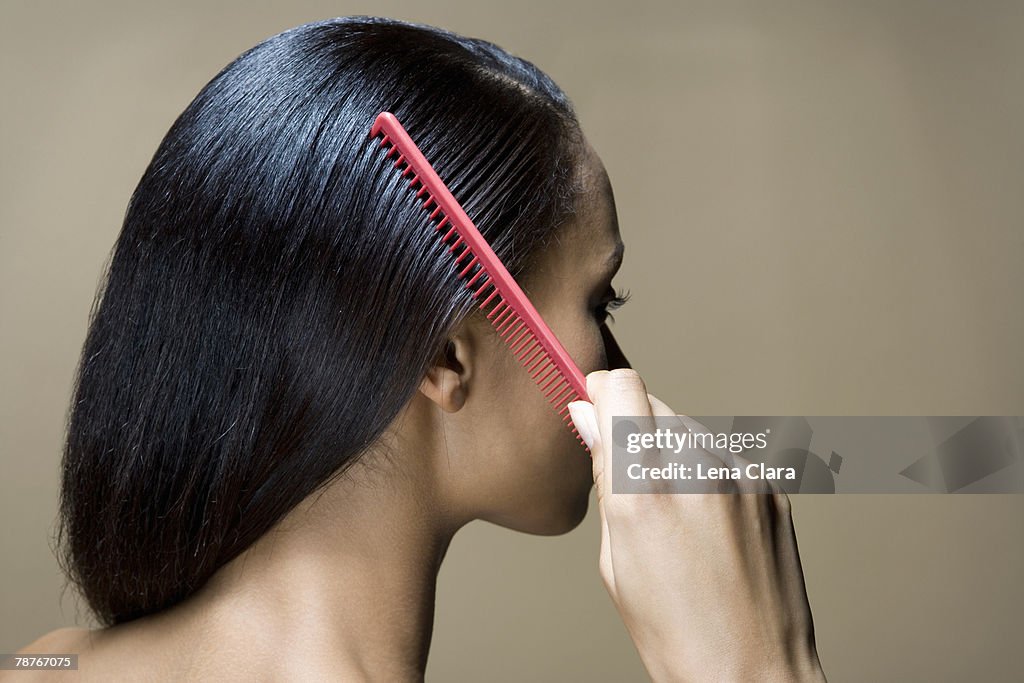 A woman combing her hair