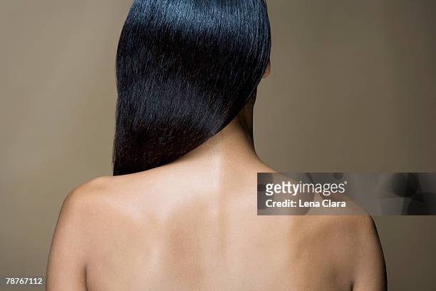 rear view of a woman with long black hair - back of womens heads stockfoto's en -beelden