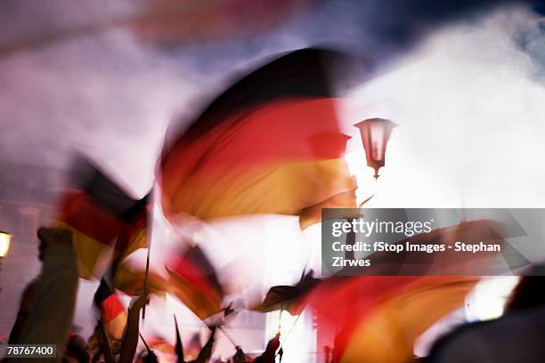 people waving german flags in fog - duitse vlag stockfoto's en -beelden