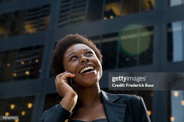 businesswoman downtown on mobile phone - mouth thinking stockfoto's en -beelden