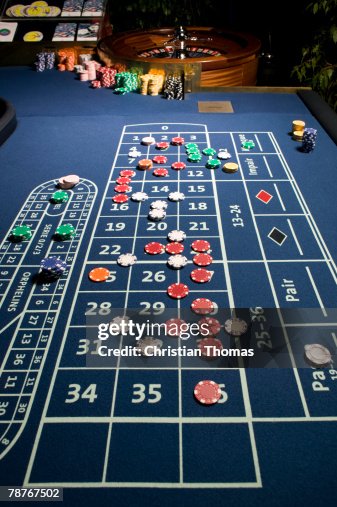 Roulette Table and Wheel with bets placed Roulette Table and Wheel with bets placed
