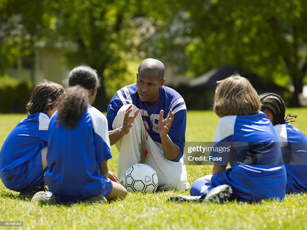 Soccer Coach Talking to Players