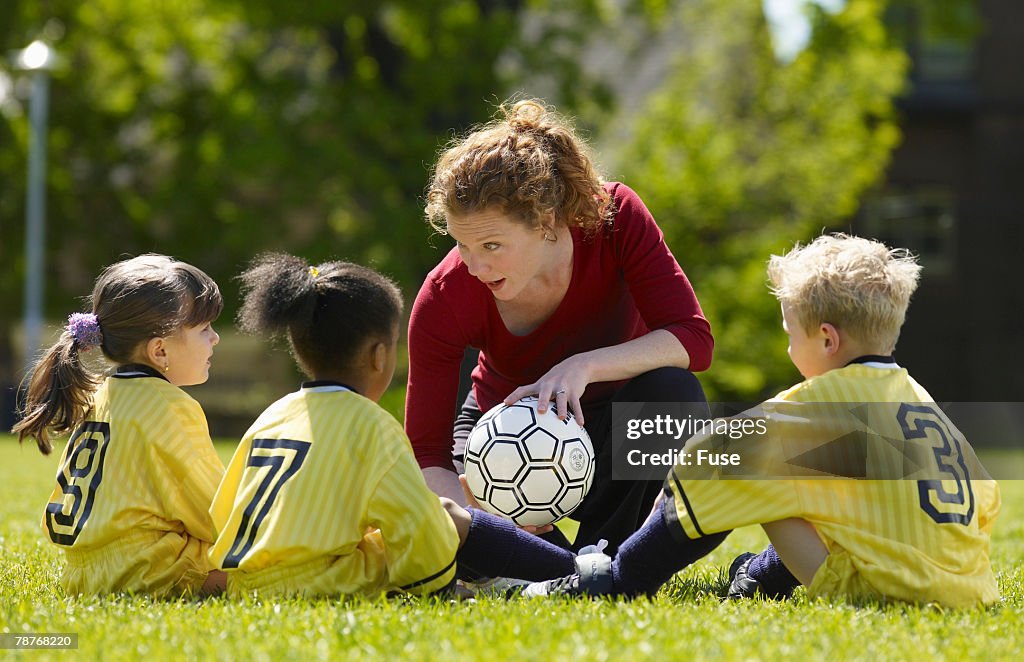 Coach and Soccer Players During Practice