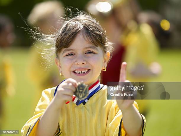 young soccer player celebrating win - sportsperson medal stock pictures, royalty-free photos & images