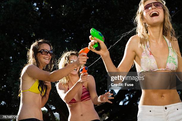 teenage girls with squirt guns - young teen bathing suit stock pictures, royalty-free photos & images