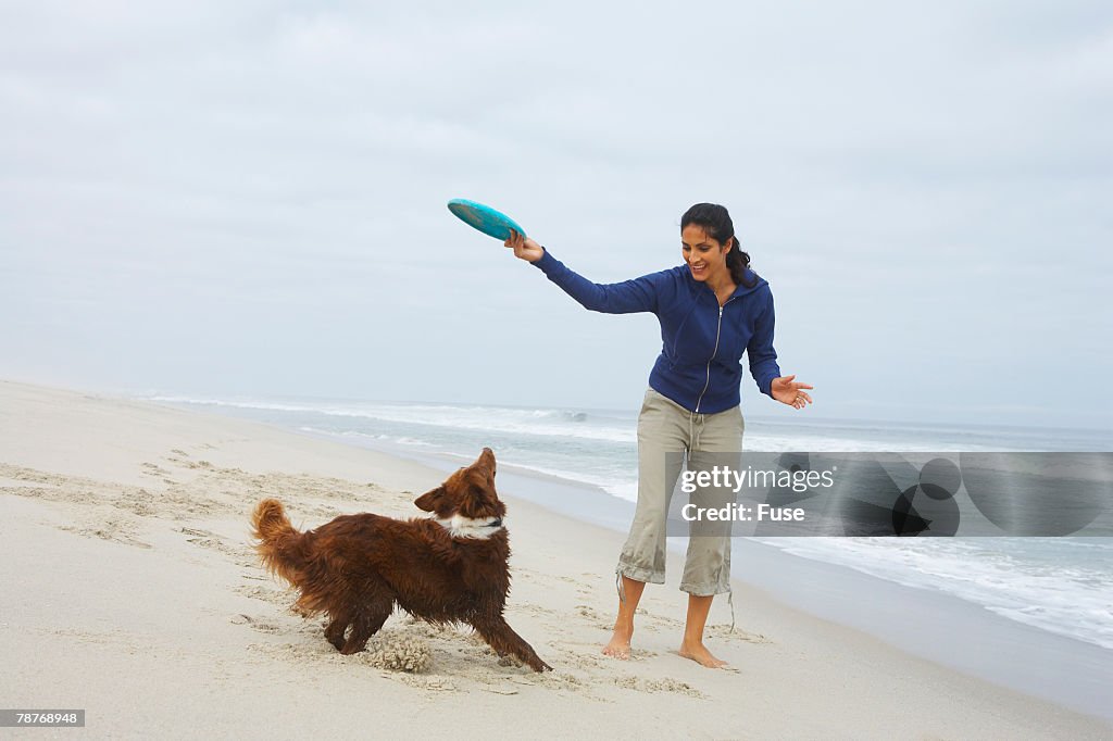 Woman Playing Frisbee with Dog