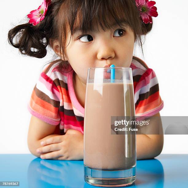 girl enjoying chocolate milk - chocolate milk stock pictures, royalty-free photos & images