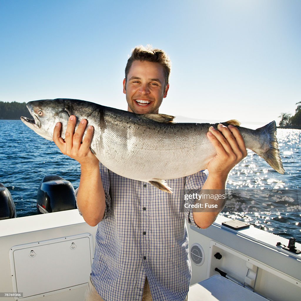 Man Getting Fish Excited Young Man Holding Fishing Catch High-Res Stock Photo - Getty Images