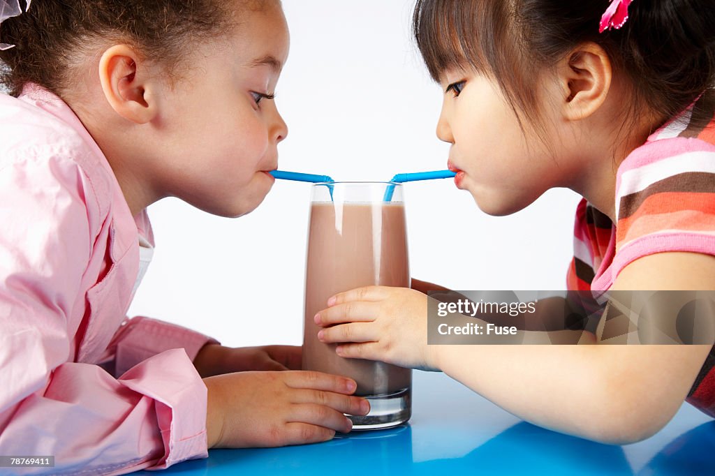 Girls Sharing Chocolate Milk