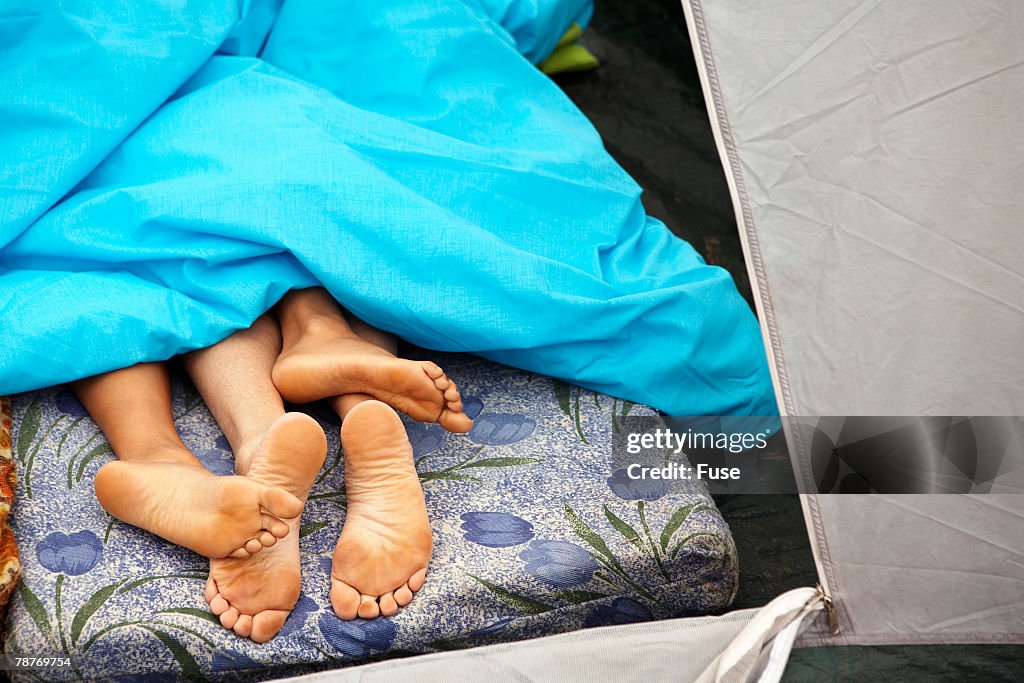 Couples Feet Under Blanket