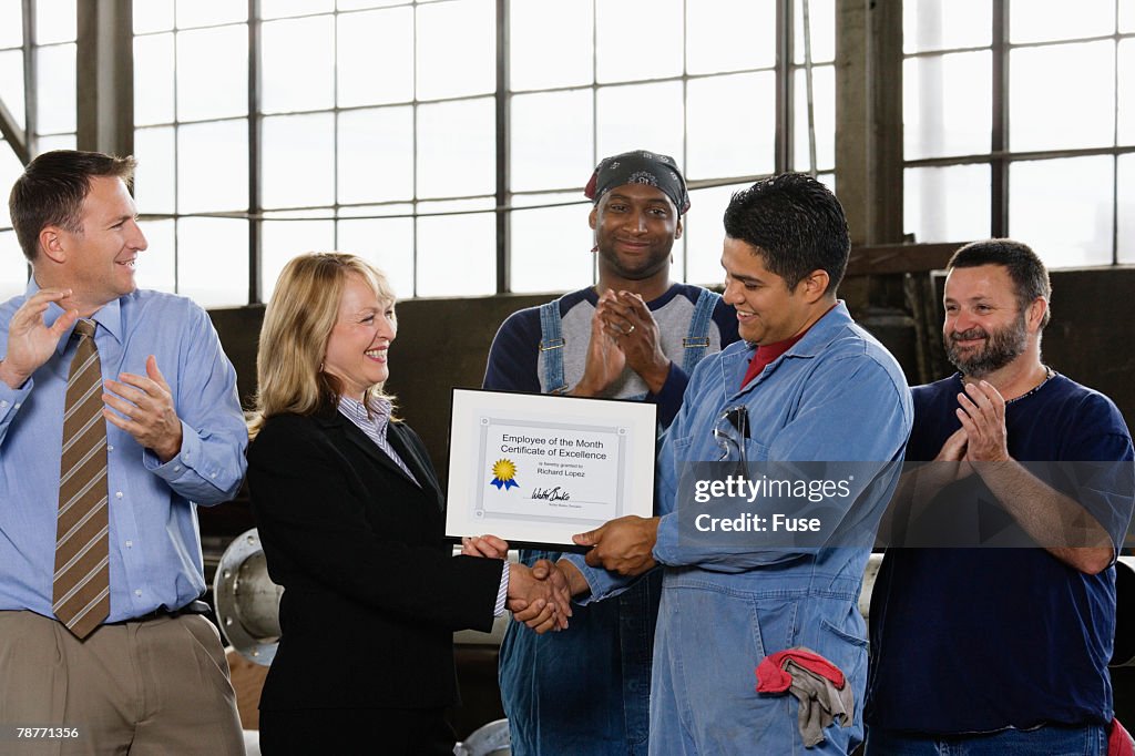 Factory Worker Receiving Certificate