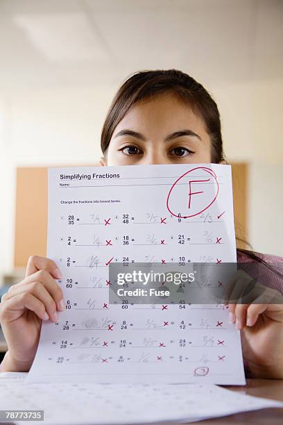 student holding test with f grade - miss f stock pictures, royalty-free photos & images