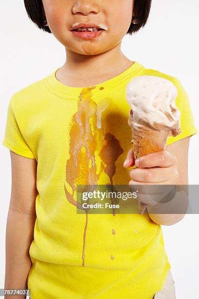 girl eating ice cream cone - girl eating messy ice cream cone stock-fotos und bilder