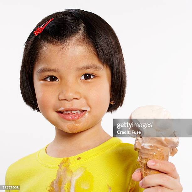 girl eating ice cream cone - girl eating messy ice cream cone stock-fotos und bilder