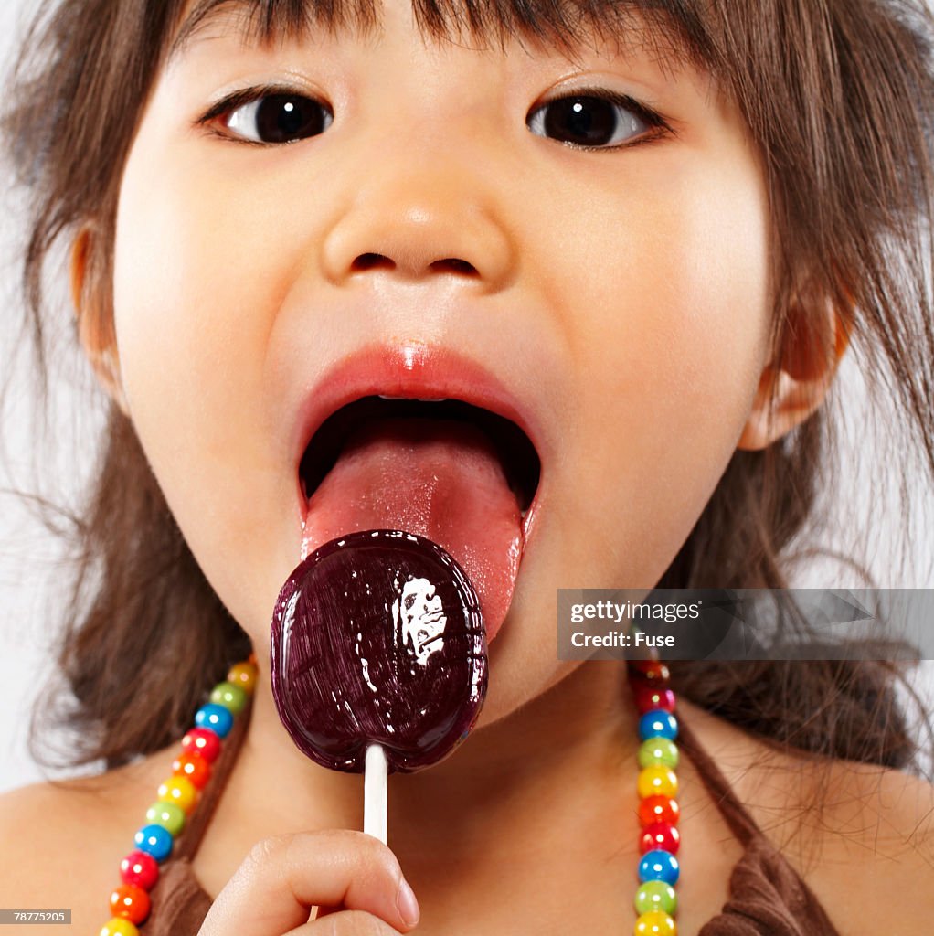 Girl Licking Lollipop