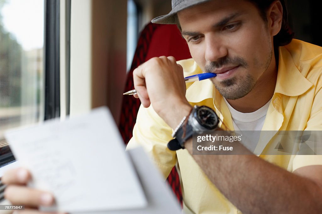 Man Writing Postcards