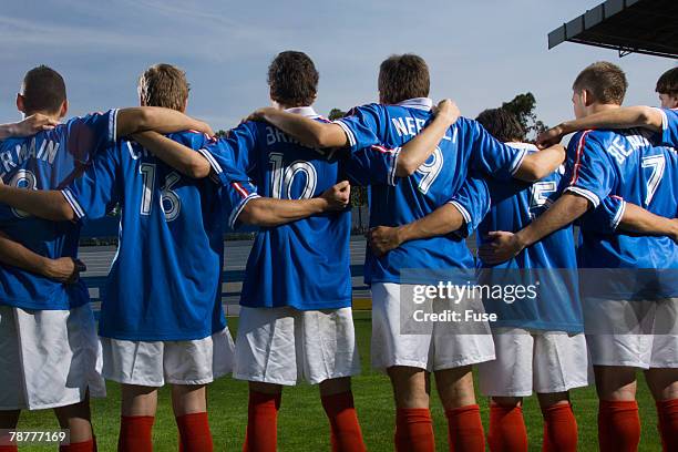 soccer players in a row at stadium - professional soccer team stock pictures, royalty-free photos & images