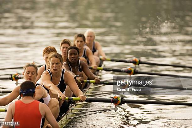 racing boat crew during practice - mixed race woman stockfoto's en -beelden