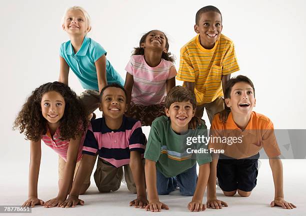 children balancing on each other - pyramid with eye stock pictures, royalty-free photos & images