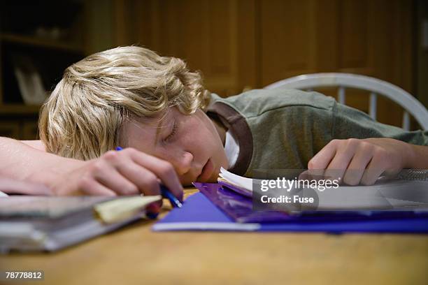 asleep while doing homework - one teenage boy only fotografías e imágenes de stock