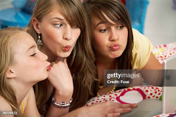 girls smooching at a web cam - cam girl stock pictures, royalty-free photos & images