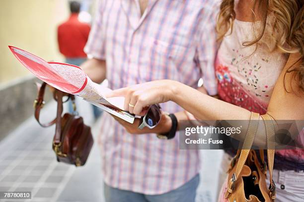 couple reading map in narrow street - city map with points of interest stock pictures, royalty-free photos & images