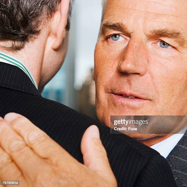 two businessmen hugging - age discrimination stock pictures, royalty-free photos & images