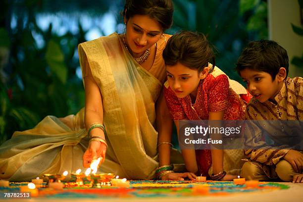 family looking at <kolam>, or <rangoli> drawings - indian kolam stock-fotos und bilder