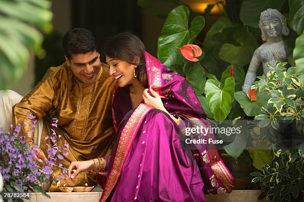 happy couple lighting candles - commencement ceremony stock pictures, royalty-free photos & images