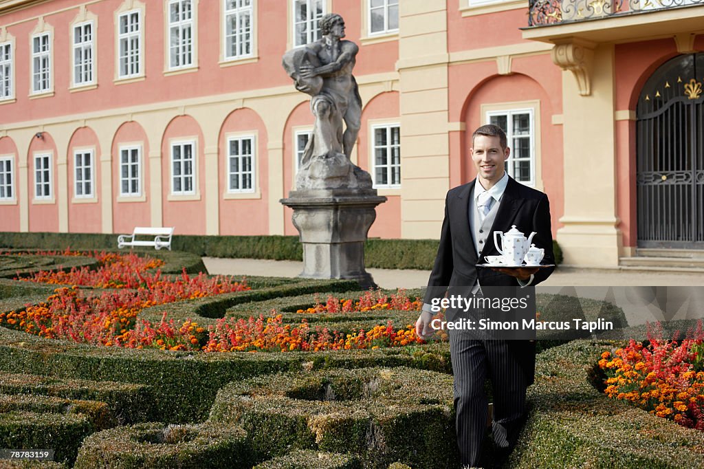 Butler Tea Ritual Butler Serving Tea At Manor House Photo - Getty Images