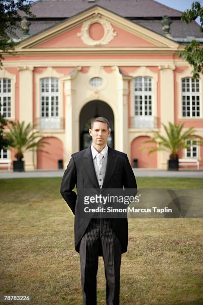 butler standing in front of manor house - tail coat stock pictures, royalty-free photos & images