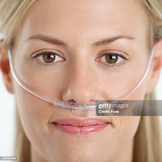 woman wearing nasal cannula for supplemental oxygen - nasal cannula ストックフォトと画像