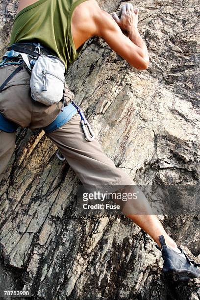 young man rock climbing - chalk bag stock-fotos und bilder