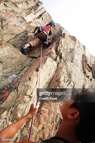 woman rock climbing - physical geography ストックフォトと画像