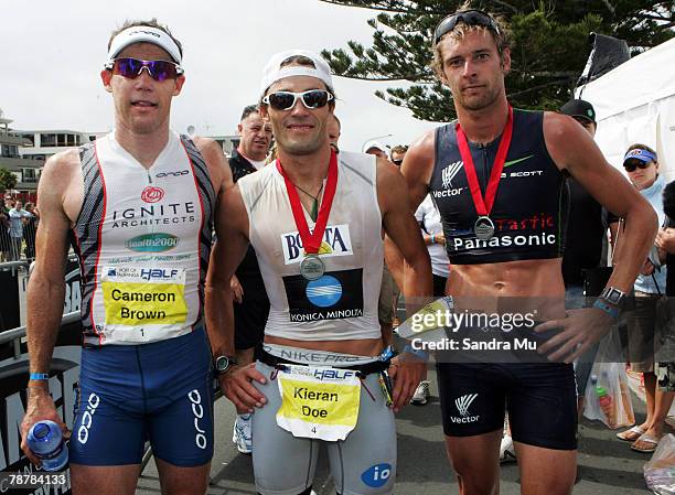 Top three finishers Cameron Brown, Kieran Doe and Nathan Richmond of New Zealand pose together after the Port Of Tauranga Half Ironman Triathlon at...