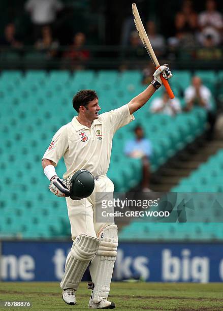 Australian batsman Mike Hussey raises his arms after reaching his century on the final day of the second Test match against India at the Sydney...
