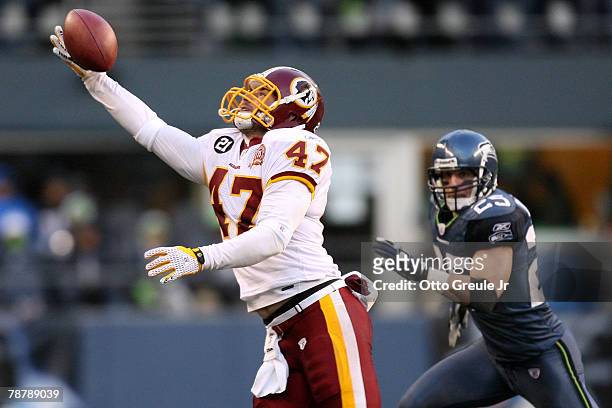 Tight end Chris Cooley of the Washington Redskins makes a one-handed catch in front of Brian Russell of the Seattle Seahawks in the third quarter...