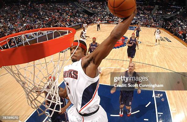 Josh Smith of the Atlanta Hawks dunks against the New Jersey Nets at Philips Arena on January 5, 2008 in Atlanta, Georgia. NOTE TO USER: User...