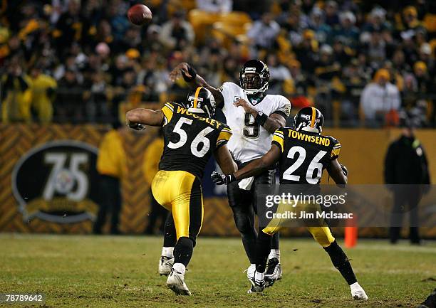 David Garrard of the Jacksonville Jaguars passes the ball over LaMarr Woodley and Deshea Townsend of the Pittsburgh Steelers during the second half...