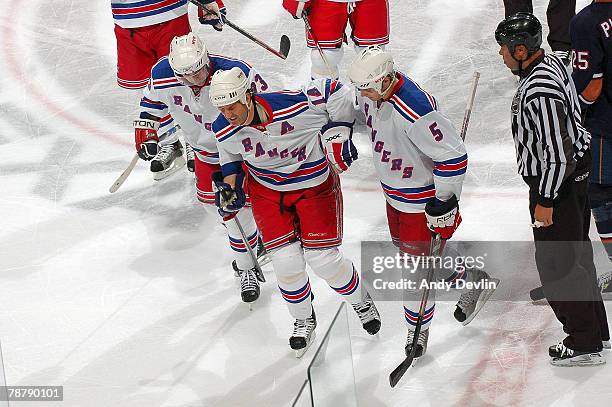 Teammates help Brendan Shanahan of the New York Rangers off the ice after he was hit by Dustin Penner of the Edmonton Oilers at Rexall Place on...