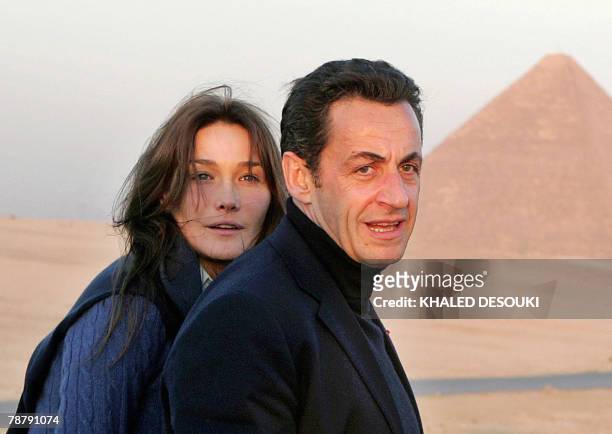 Picture taken 30 December 2007 shows French President Nicolas Sarkozy and his model-turned-singer girlfriend Carla Bruni posing near the Great...