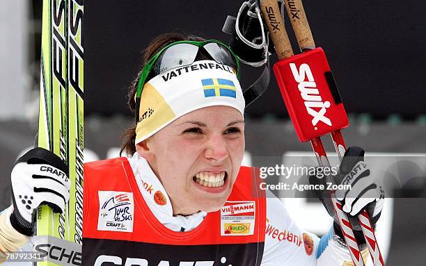 Charlotte Kalla of Sweden winner of the yellow bib celebrates taking 1st place during stage eight of the FIS Tour de Ski Women's 9KM Final Climb...