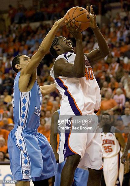 James Mays of the Clemson Tigers is fouled by Danny Green of the North Carolina Tar Heels as he goes up for this shot at Littlejohn Coliseum January...