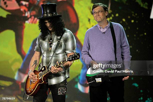 Microsoft chairman Bill Gates watches as musician Slash plays a Gibson Les Paul electric guitar during the opening keynote address at the 2008...