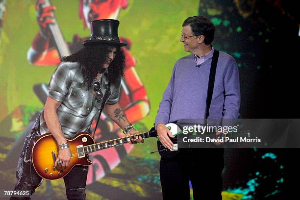 Microsoft chairman Bill Gates watches as musician Slash plays a Gibson Les Paul electric guitar during the opening keynote address at the 2008...