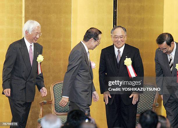 Japanese Prime Minister Yasuo Fukuda exchanges bows with Japan's business group leaders Toshiba's Tadashi Okamura of Japan Chamber of Commerce and...