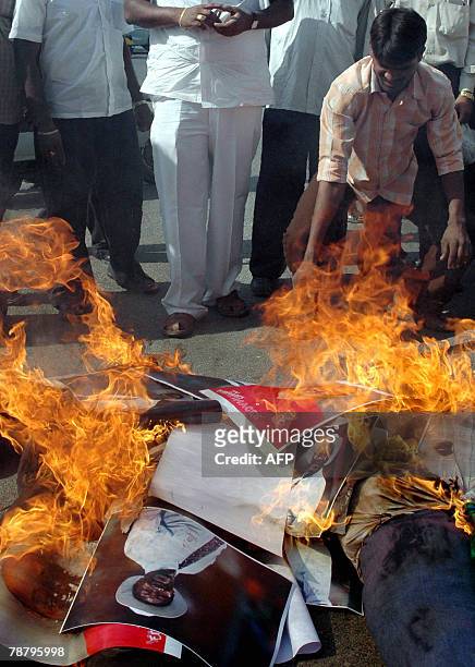 Indian demonstrators burn effigies and photographs of umpires Steve Bucknor and Mark Benson during a demonstration in Hyderabad, 07 January 2008,...