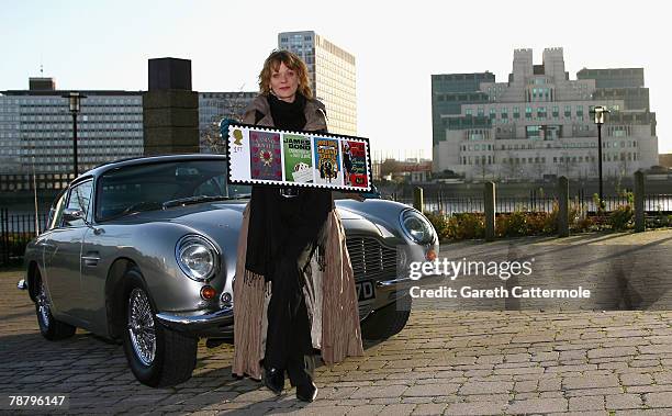 Actress Samantha Bond, who played Miss Moneypenny in the James Bond films, poses with an Aston Martin DB6 to launch a new set of stamps from The...