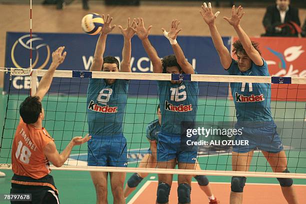 Alberto Cisella, with teammates Vigor Bovolenta and Hristo Zlatanov of Italy try to block the ball against Jeroen Paul Trommel of The Netherlands, in...